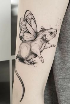 a woman with a tattoo on her arm has a rat in the shape of a butterfly