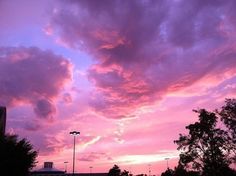 the sky is pink and purple with clouds