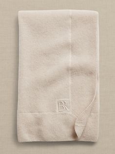 a folded white towel with the letter r on it