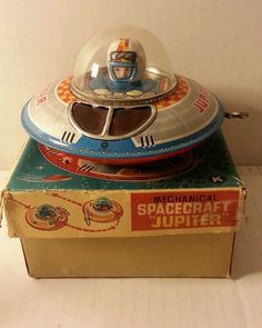 an old toy space shuttle sitting on top of a box