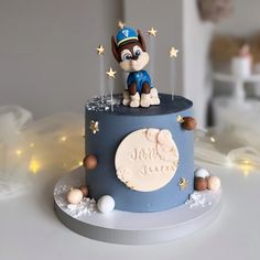 a birthday cake with a dog on top and stars around the edges that spell out