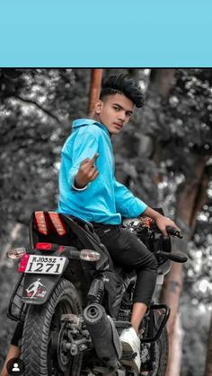 a young man riding on the back of a motorcycle