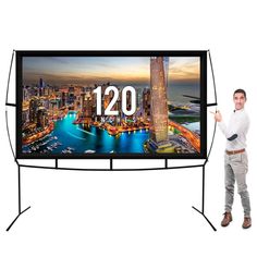 a man standing in front of a large screen tv with the number twenty on it