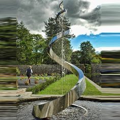 a water fountain in the middle of a park