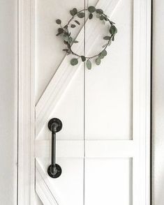 a door with a wreath hanging on it