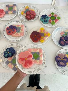 a table topped with plates filled with different types of cookies