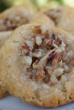 three cookies on a plate with pecans in the middle