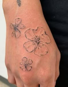 a person with a flower tattoo on their hand