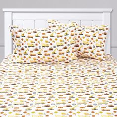 a bed with yellow and orange train sheets