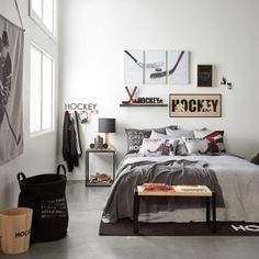 a bed room with a neatly made bed and pictures on the wall