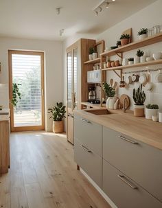 the kitchen is clean and ready for us to use it's natural wood flooring