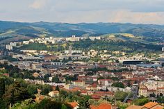 the city is surrounded by hills and trees