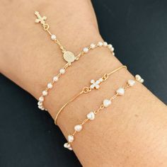 Gold Rosary Bracelet: As an accessory, the gold rosary bracelet is a wearable expression of faith. Combine elegance with a sacred symbol. Cross Bracelet: Symbolic of Christianity, the crucifix bracelet represents faith and devotion.  Pearl Heart Bracelet: Elegant and feminine, the pearl heart bracelet is a romantic accessory suitable for special occasions or as a timeless piece. - Bracelet Length: 7.5 inches - Pearl Heart Width: 4 mm - Cross Size: 6.5 mm - Crucifix Width: 3mm It is equipped with Cheap Gold Rosary Bracelet, Adjustable Gold Dainty Rosary Bracelet, Dainty Adjustable Rose Gold Rosary Bracelet, Adjustable Rose Gold Dainty Rosary Bracelet, Adjustable Dainty Rose Gold Rosary Bracelet, Catholic Rosary Bracelet, Bracelet Rosary, Gold Rosary, Beautiful Anklet