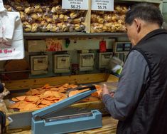 a man standing in front of a counter filled with food