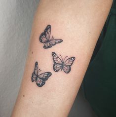 three butterflies tattoo on the arm