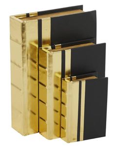 three black and gold bookends sitting next to each other