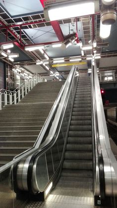 an escalator in a subway station that is empty