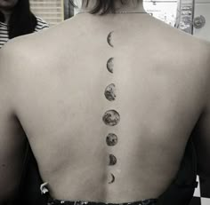 the back of a woman's neck with phases on it