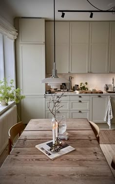 a wooden table sitting in front of a window