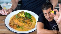 a man sitting at a table with a plate of food