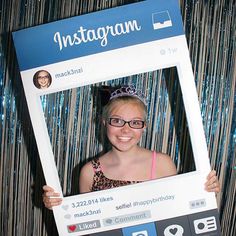 a woman holding up a photo frame with the word instagram on it