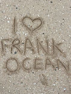 i love frank ocean written in the sand with a heart on it's side