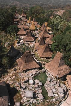 an aerial view of a village with thatched roofs