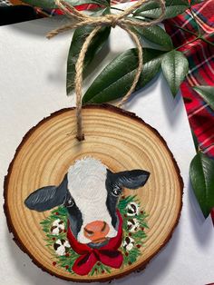 a wooden ornament with a cow on it