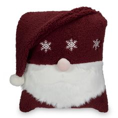 a red and white santa claus pillow with snowflakes on its eyes, nose and mouth