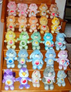 many different colored teddy bears are on the stairs