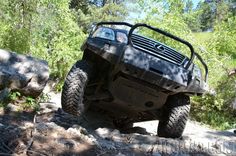 an off - road vehicle driving through the woods