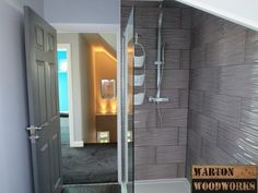 a bathroom with a walk in shower next to a wooden sign