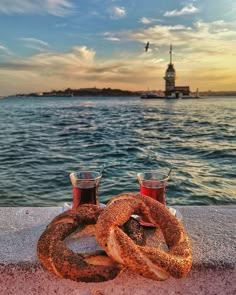 two pretzels sitting on the edge of a pier