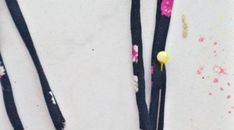 three pieces of black fabric with pink and yellow flowers on them next to each other