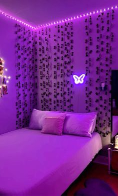 a bedroom with purple lighting and decorations on the wall