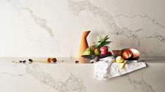 an assortment of fruit on a marble counter top