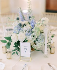 a table with flowers and candles on it