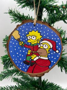 a christmas ornament hanging from a tree with the image of homer simpson on it