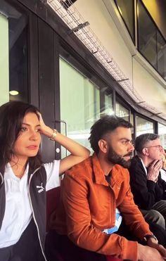 two people sitting next to each other on a bus