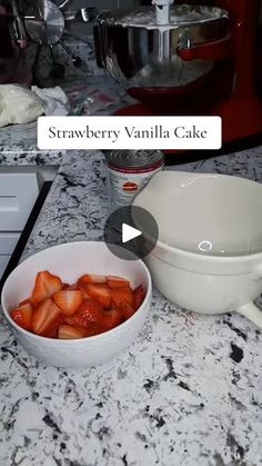 a bowl of strawberries sitting on top of a counter