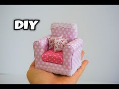 a hand holding a miniature pink chair with white polka dots on it and the words diy above it