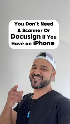 a man with a hat on holding up his cell phone to the camera and smiling