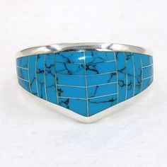 "Large beautiful blue faux turquoise sterling silver hinged cuff bracelet.  Marked 925.  Certain to be a treasure in your personal jewelry collection. FREE SHIPPING! Details:  Sterling Silver: (as shown in picture) Faux Turquoise: inlay Approximate Dimensions: 1 1/2 inch wide at top, inside circumference is 6 3/4 inches Wrist Size: 6 - 6 1/2 inches  Total Weight: 78.0 grams FREE domestic shipping by USPS Priority Mail delivery confirmation and includes insurance. If the item is to be shipped internationally Etsy will calculate postage. Please notify us at purchase if you are buying more than one item and we will gladly combine shipping. 7 day \"no hassle\" return policy money back guarantee. If for any reason you are not 100% thrilled with your purchase, please contact us and we will gladl Adjustable Blue Cuff Bracelet For Anniversary, Turquoise Stamped 925 Bangle, Blue Inlay Bracelet Jewelry, Blue Inlay Bracelet, Southwestern Style Nickel Free Blue Cuff Bracelet, Southwestern Sterling Silver Cuff Bracelet In Blue, Southwestern Blue Nickel-free Cuff Bracelet, Southwestern Style Blue Nickel-free Cuff Bracelet, Adjustable Blue Inlay Cuff Bracelet