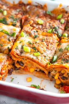 lasagna casserole with meat and vegetables in a red dish