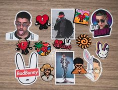 various stickers and magnets are arranged on a wooden surface, including one man's face