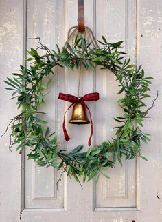 Handmade minimalist Christmas wreath, the perfect addition to your holiday decor this season! Handcrafted on a gold hoop with the addition of realistic olive branch and tied with a charming vintage style gold bell, twine and buffalo plaid ribbon. This wreath is perfect behind a storm door! Purchase today so you can start enjoying this beauty on your front door or wherever you choose to display!! * Materials: Realistic Gold Metal Hoop, Olive Branch, Small Gold Bell, Twine, Ribbon, Wire * Dimensions: 22" in diameter + 3" deep * Perfect for those with a storm door * As always, handcrafted in our small shop for you * Due to the handmade nature of our wreaths, slight variations may occur, which adds to their uniqueness * Always shipped in a sturdy box for storage after use Looking for a unique Minimalist Christmas Wreath, Olive Branch Wreath, Wreath Alternative, Branch Wreath, Fruit Wreath, Window Wreath, Christmas Wreath For Front Door, Christmas Country, Buffalo Plaid Ribbon