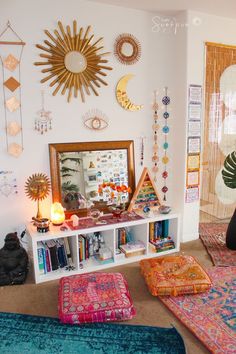 a living room filled with lots of colorful rugs and decorations on the wall above it