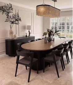 a dining room table with chairs and a chandelier