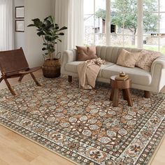 a living room filled with furniture and a large rug