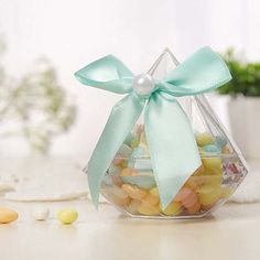 a glass bowl filled with candies on top of a table